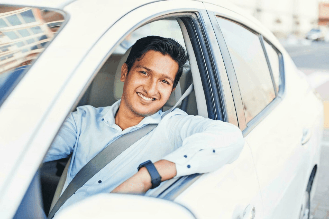 Person smiling in a car